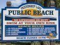 Photo of public beach sign at Friendship Lake.